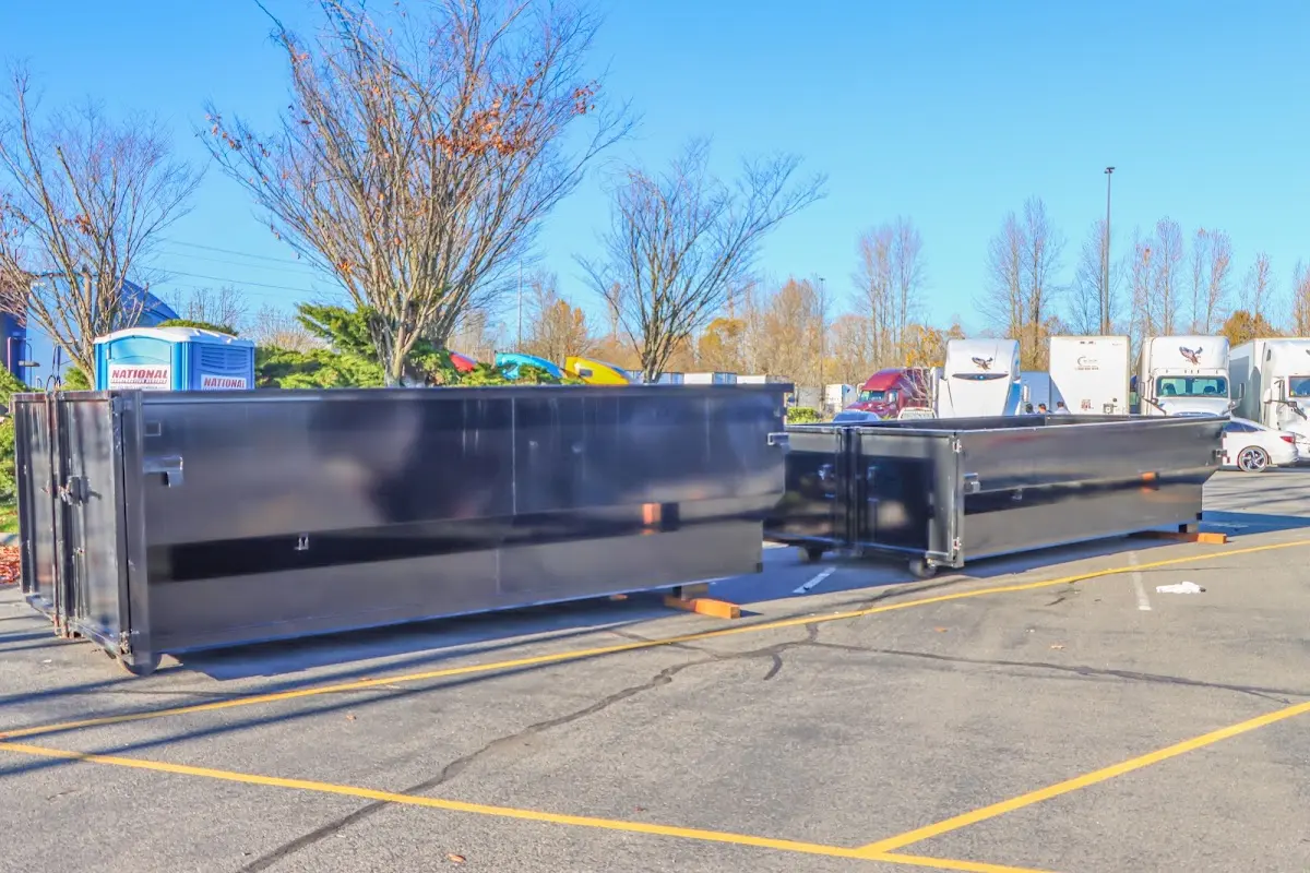 Professional dumpster rental service with roll-off container on residential driveway in Deerpark